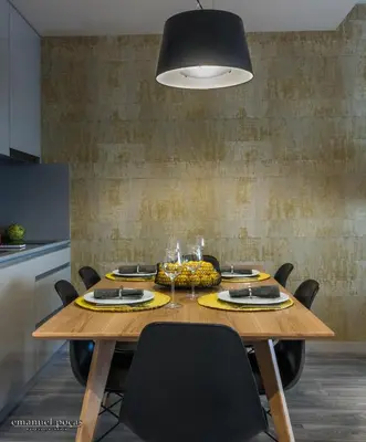 a dining room table with chairs and aendant light at Passos Manuel by Innapartments in Porto