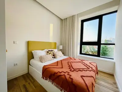 a bedroom with a bed and a large window at Oporto Chic & Cozy - Bolhão in Porto