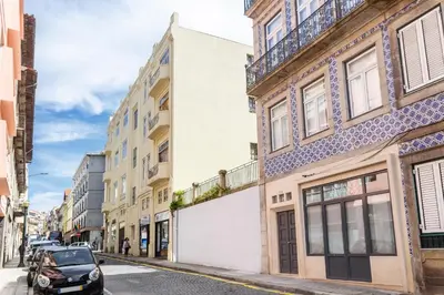 a street with buildings and a car parked on the street at Oporto Chic & Cozy - Bolhão in Porto