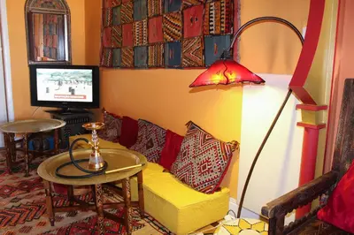 a living room with a yellow couch and a lamp at Porto Riad - Guest House in Porto