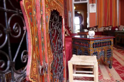 a room with a bed and a chair and a table at Porto Riad - Guest House in Porto