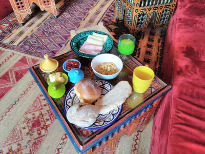 a tray of food with bread and drinks on a table at Porto Riad - Guest House in Porto