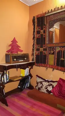 a room with a mirror and a table with a radio at Porto Riad - Guest House in Porto