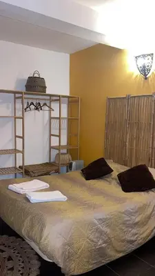 a bedroom with a large bed with towels on it at Porto Riad - Guest House in Porto