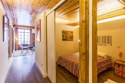 a bedroom with a bed and a wooden ceiling at Go2Oporto - Historical Center in Porto