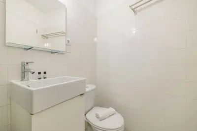 a white bathroom with a sink and a toilet at Try Oporto - São Lázaro in Porto