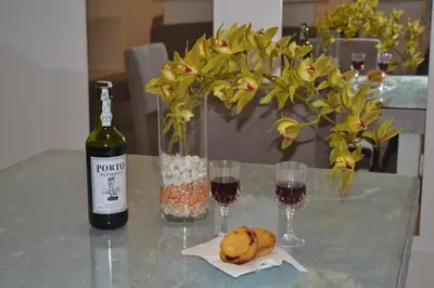 a table with a bottle of wine and two glasses at Apartamento LM Ribeira in Porto