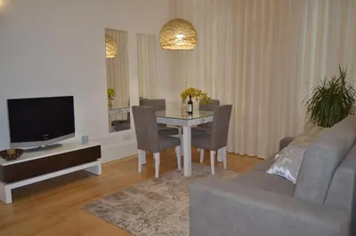 a living room with a table and a tv at Apartamento LM Ribeira in Porto