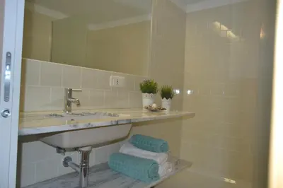 a bathroom with a sink and a mirror at Apartamento LM Ribeira in Porto