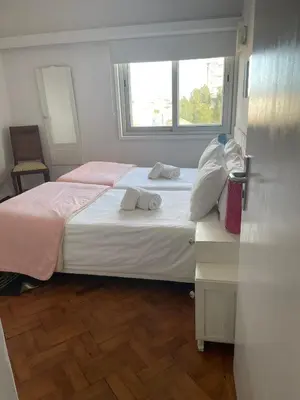 a bedroom with two beds and a window at Apartamento Vintage 2 in Porto