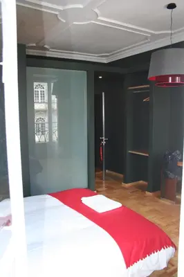 a bedroom with a white bed with a red blanket at 2U Oporto Urban Stays in Porto