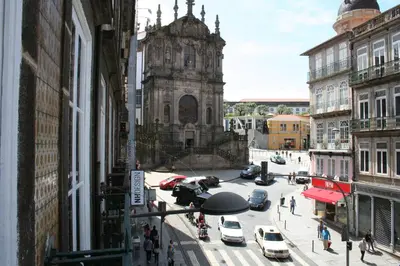 a view of a city street with cars and a church at 2U Oporto Urban Stays in Porto