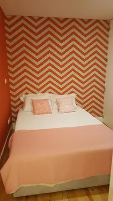 a bed with two pillows on it in a room at SBV Perfect River View in Porto