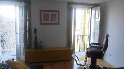 a living room with a door to a balcony at SBV Perfect River View in Porto
