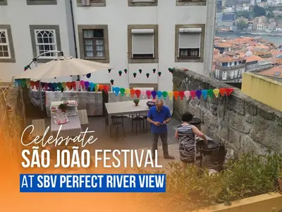 a man and a boy standing on a balcony with an umbrella at SBV Perfect River View in Porto
