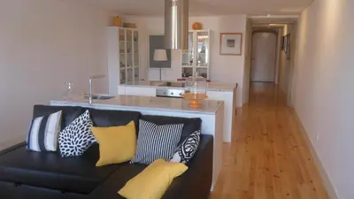 a living room with a black couch with pillows at SBV Perfect River View in Porto