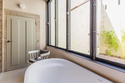a bedroom with a bed and a window at Armazém Luxury Housing- Architectural & Design Hotel in Porto