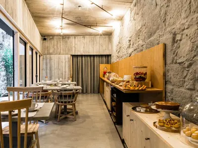a kitchen with a counter and a table with food at Armazém Luxury Housing- Architectural & Design Hotel in Porto
