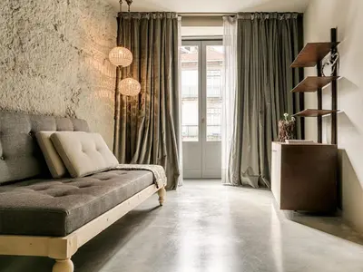 a living room with a couch and a large window at Armazém Luxury Housing- Architectural & Design Hotel in Porto