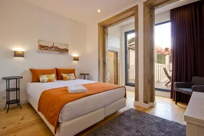a bedroom with a bed and a large window at MyStay Porto Bolhão in Porto