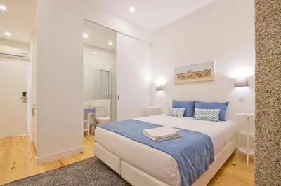 a bedroom with a large white bed with pillows at MyStay Porto Bolhão in Porto