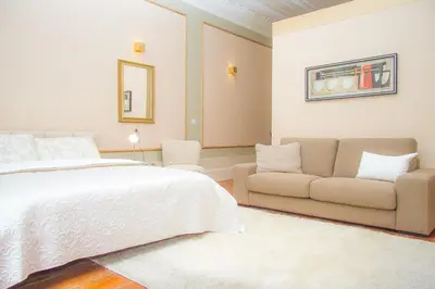 a bedroom with a bed and a couch at Liiiving in Porto | Art & Heart Studio in Porto