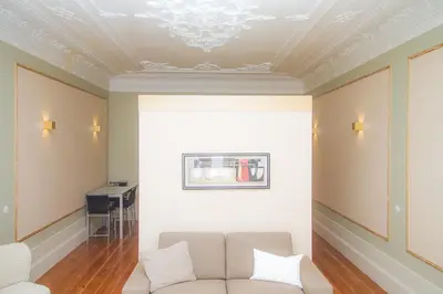 a living room with a couch and a coffered ceiling at Liiiving in Porto | Art & Heart Studio in Porto
