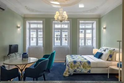 a bedroom with a bed and a table and chairs at Oporto Welcome Apartments - Santa Catarina in Porto