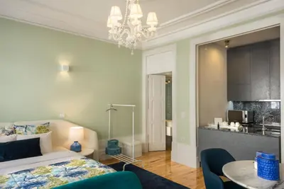 a bedroom with a bed and a table with chairs at Oporto Welcome Apartments - Santa Catarina in Porto