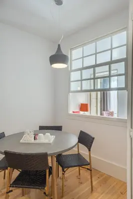 a dining room with a table and chairs and a window at Oporto Welcome Apartments - Santa Catarina in Porto