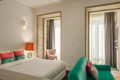 a bedroom with a bed and a couch at Oporto Welcome Apartments - Santa Catarina in Porto