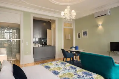 a room with a bed and a table with chairs at Oporto Welcome Apartments - Santa Catarina in Porto