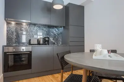 a kitchen with a table and a counter top at Oporto Welcome Apartments - Santa Catarina in Porto