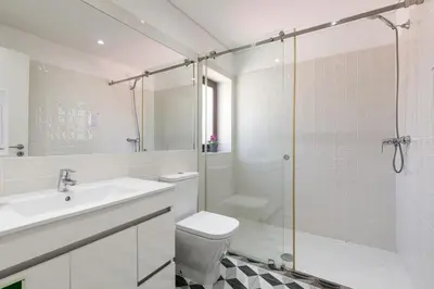 a bathroom with a toilet and a sink and a shower at BRA.com Apartments Oporto Pinheiros in Porto