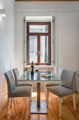 a dining room with a glass table and chairs at BRA.com Apartments Oporto Pinheiros in Porto