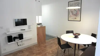 a living room with a table and a tv at Casa da Catedral in Porto