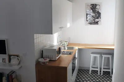 a small kitchen with a microwave on a counter at Casa da Catedral in Porto