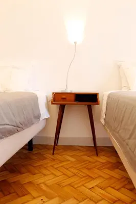 a bed room with a table between two beds at Casa da Catedral in Porto