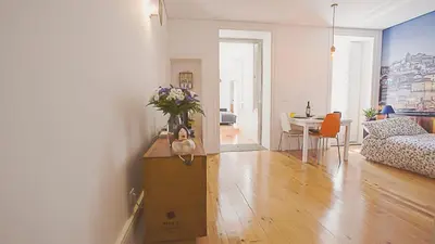a living room with a box with a vase of flowers on it at BmyGuest - Almada Garden Apartment in Porto
