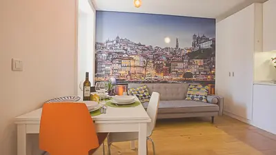 a living room with a table and a couch with a city at BmyGuest - Almada Garden Apartment in Porto