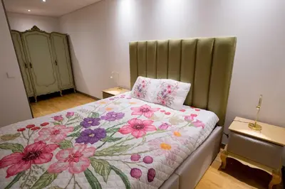 a bedroom with a bed with a floral blanket at GuestReady - Eiffel Waterfront apartments in Porto