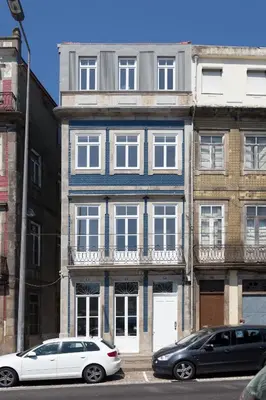 a bedroom with a bed and a glass door at Seventyset Flats - Porto Historical Center in Porto