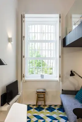 a living room with a couch and a kitchen at Seventyset Flats - Porto Historical Center in Porto