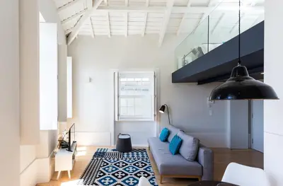 an attic room with a bed and a glass staircase at Seventyset Flats - Porto Historical Center in Porto