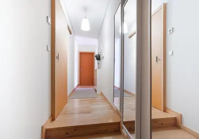 a hallway with a mirror and wooden floors at OPO Trinta e um in Porto