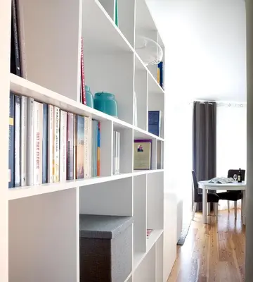 a book shelf with books on it in a living room at OPO Trinta e um in Porto
