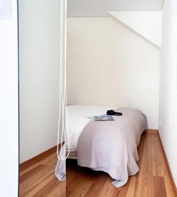 a bed in a room with a swing at OPO Trinta e um in Porto