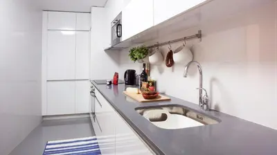 a kitchen with a sink and a counter top at OPO Trinta e um in Porto