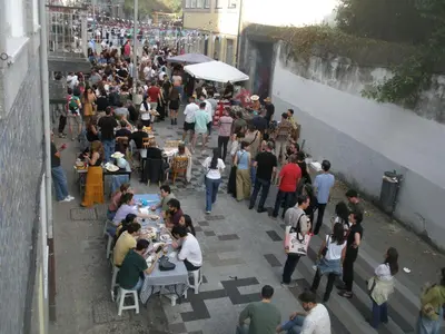 a crowd of people standing and sitting at tables at Porto.arte downtown apartment in Porto