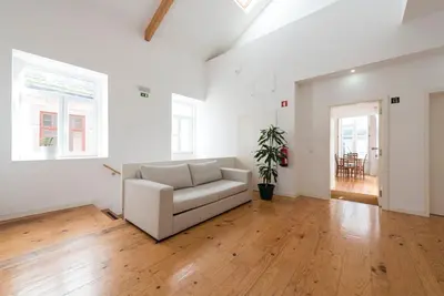 a living room with a white couch and wooden floors at Apartment Firehouse by Sweet Porto - Free Parking in Porto